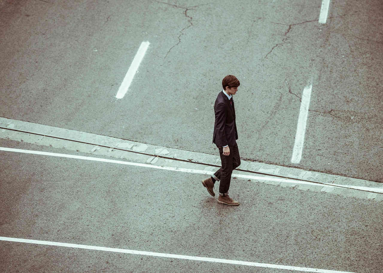 Image of a businessman walking in a crosswalk