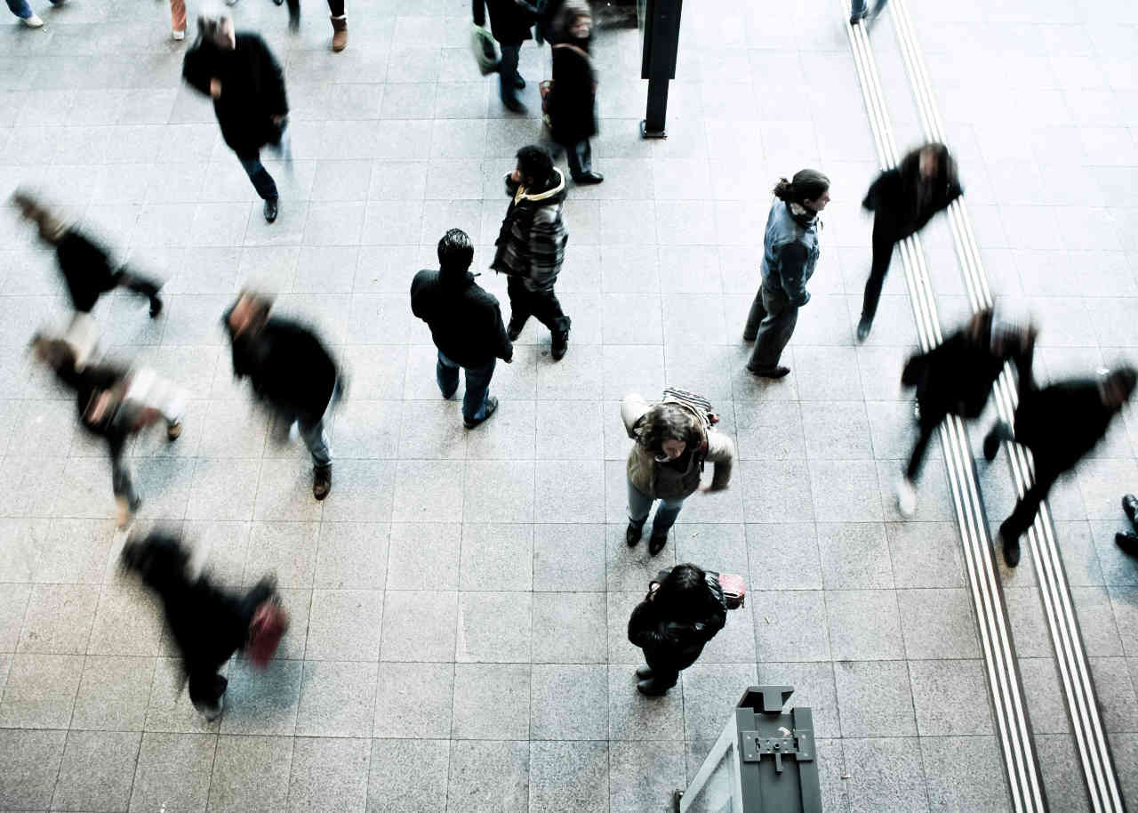 Image of commuters walking in a train station