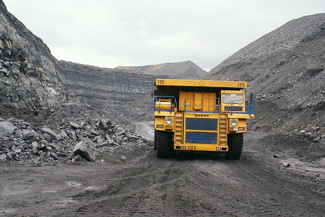 Image of yellow mining truck at a mining site.