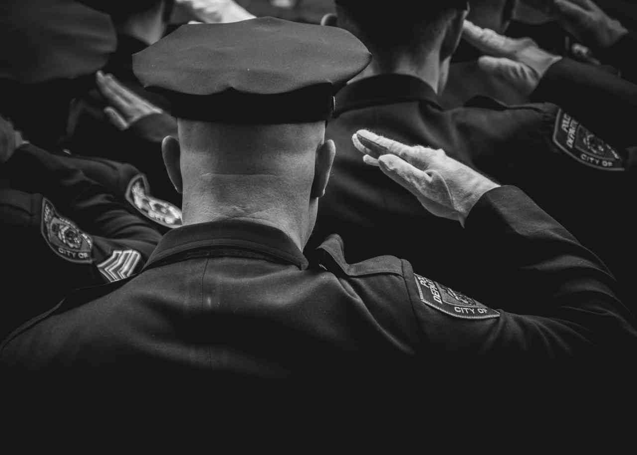Image of saluting police officers