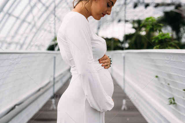 Image of a pregnant woman in a white dress