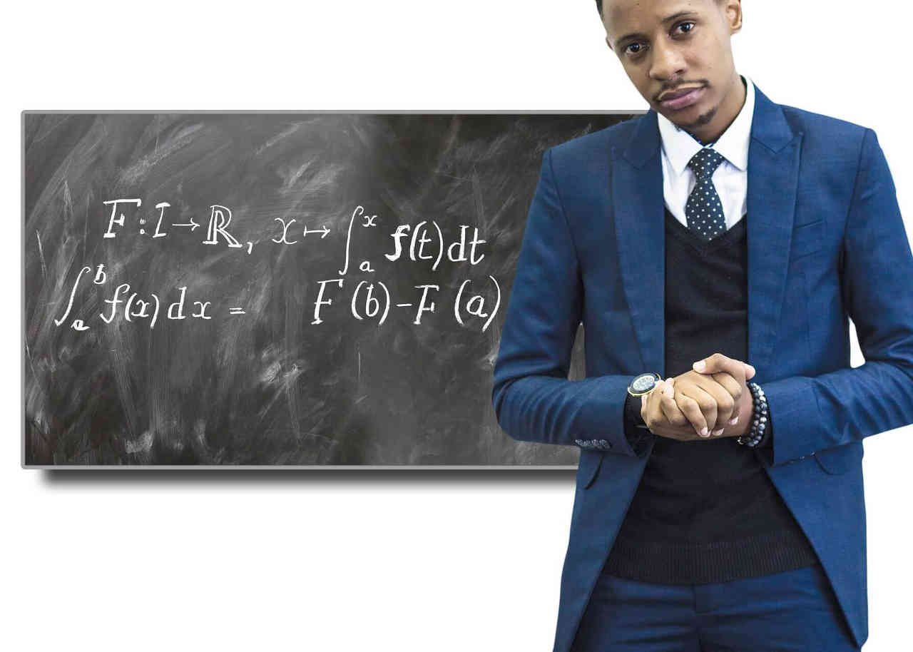 Image of a professor standing at a chalkboard