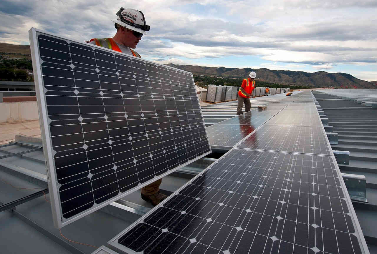 Image of workers installing solar panels.